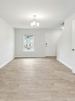Bright and open living room with wooden floors, ideal for modern living.